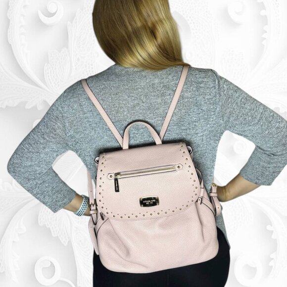 Michael Kors Riley small pebbled leather flap backpack in a light pink color main image 6